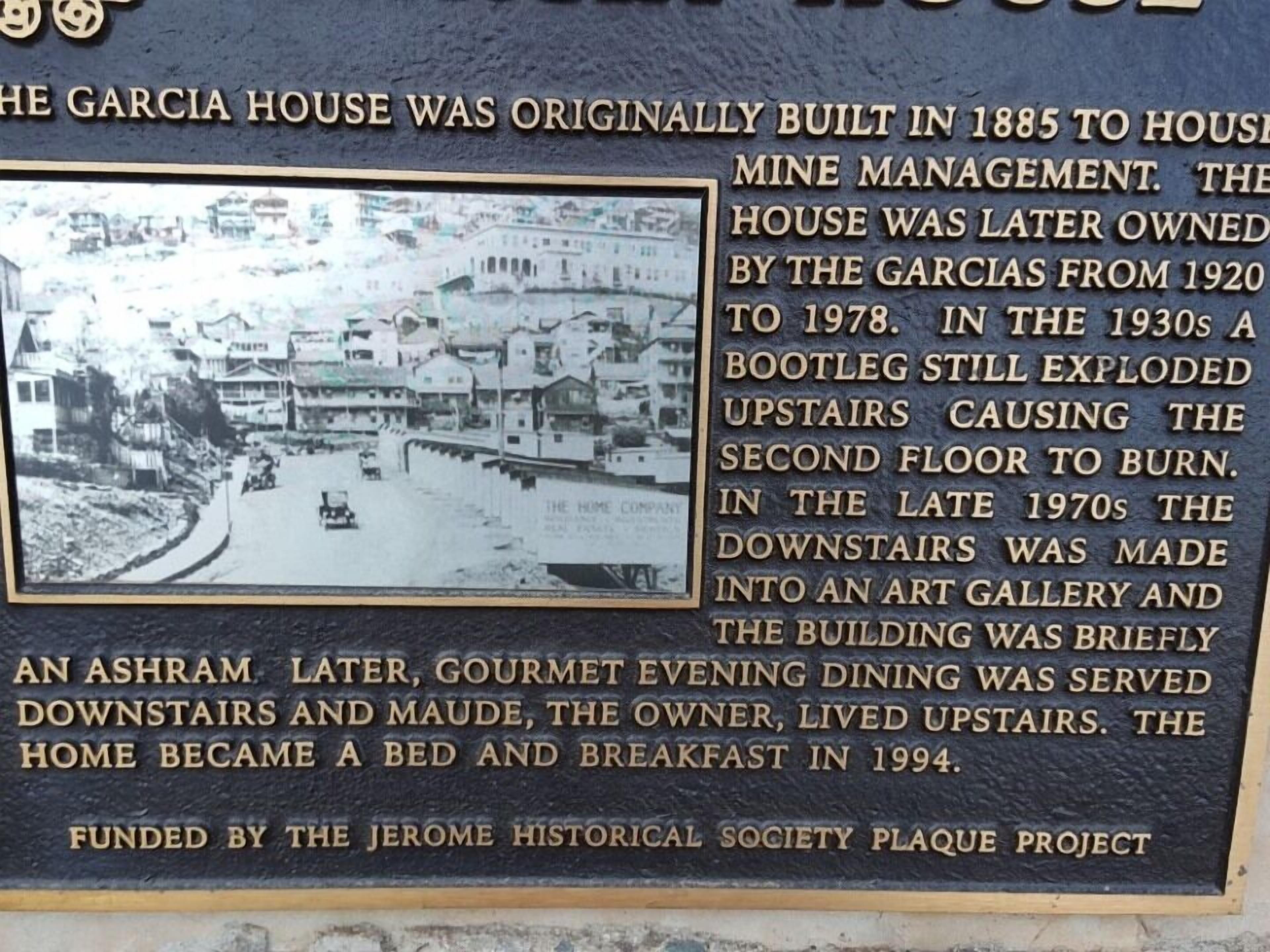 A historical plaque detailing the history of the Garcia House, including its original purpose, ownership changes, and transformations over time.
