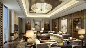 A luxurious living room with a large chandelier, comfortable seating, a fireplace, and a television. - DoubleTree by Hilton Hotel Shiyan (Shiyan)