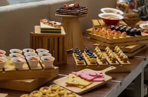 A buffet table with various food items including pastries, fruits, and cheeses. - DoubleTree by Hilton Shanghai Hongqiao (Shanghai)