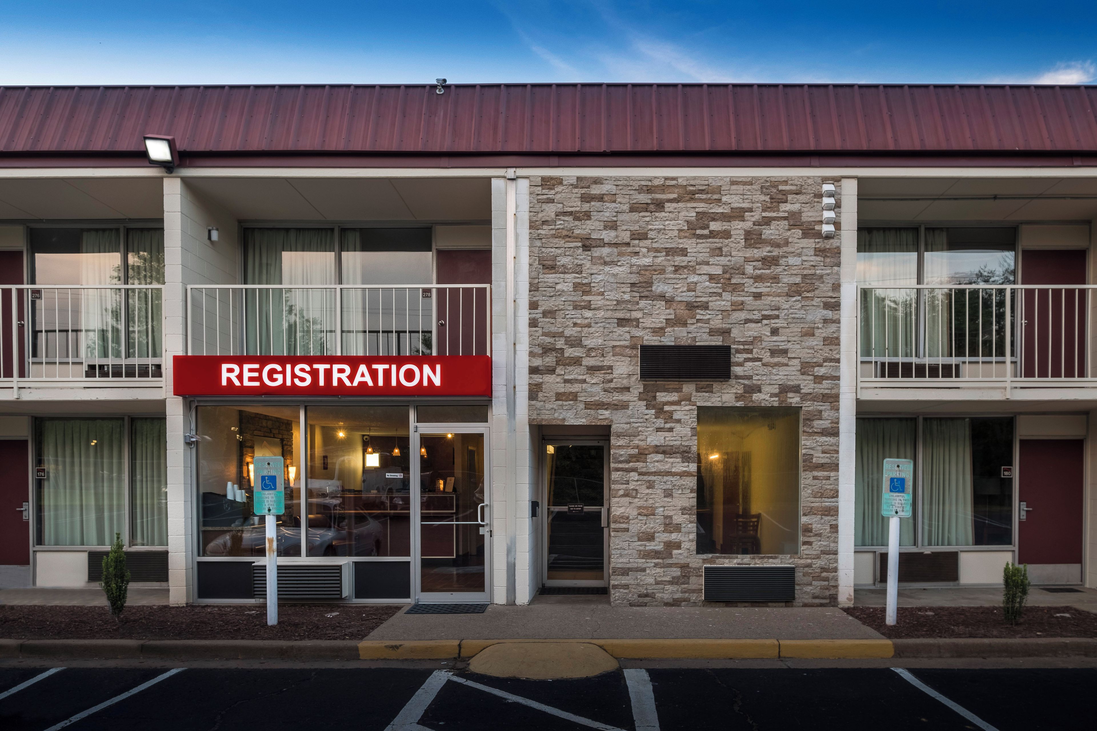 A building with a registration sign, multiple balconies, and a stone facade.