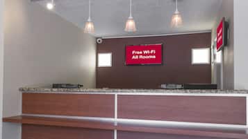 A reception desk with a sign indicating free Wi-Fi availability.
