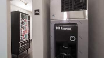 A hallway with an ice dispenser and vending machine.