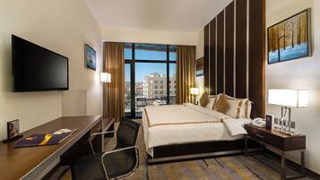 Standard Double Room | Minibar, in-room safe, desk, blackout drapes