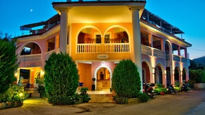 A two-story building with a balcony, arched windows, and a sign reading "KYPRIANOS". - Kyprianos (Zakynthos)