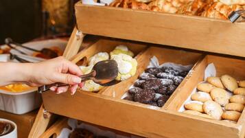 A wooden display case with various baked goods.