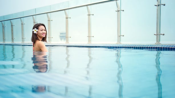 A pool with clear blue water and a glass railing. - ibis Saigon Airport (Ho Chi Minh City)