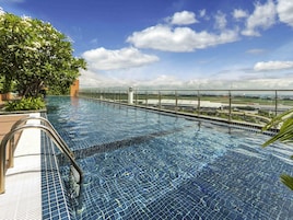 Outdoor pool, open 6:00 AM to 10:00 PM, pool umbrellas, sun loungers