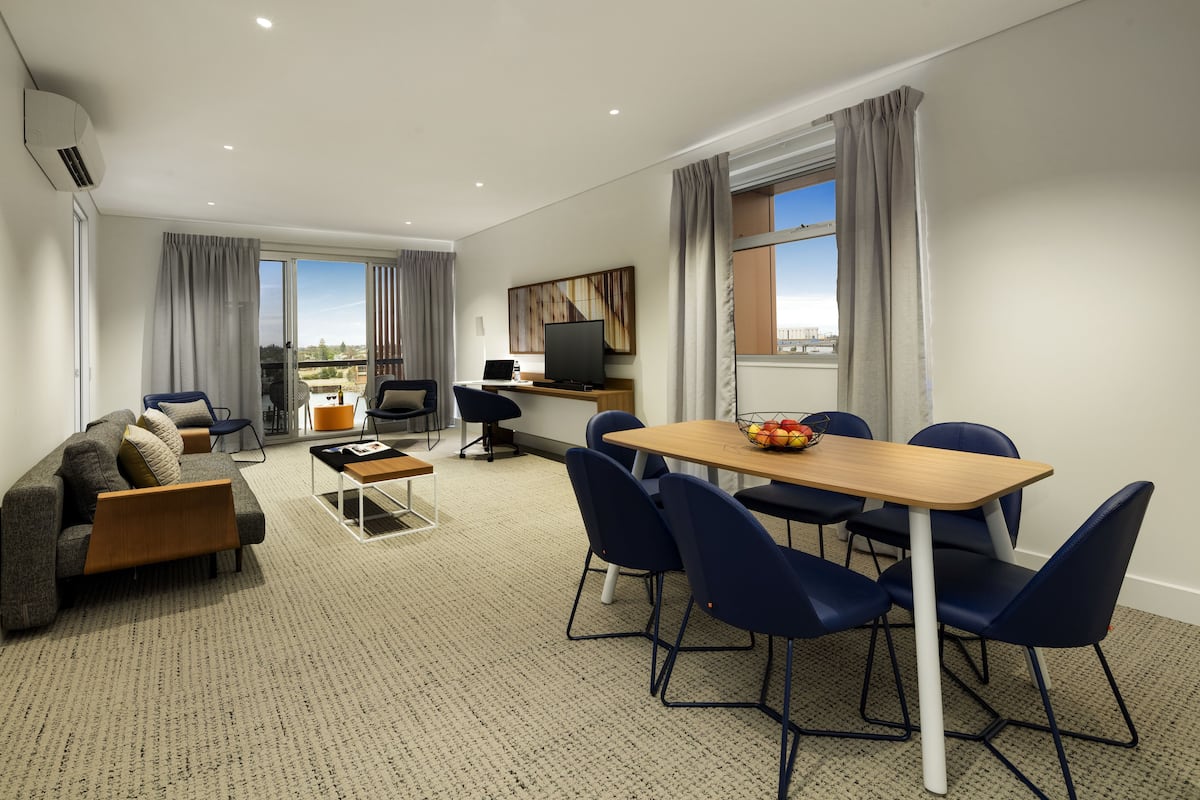 Three Bedroom with Balcony | Living area | Flat-screen TV, books