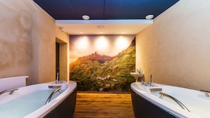 A bathroom with two large tubs, wooden flooring, and a scenic mural on the wall. - Hotel Anglický Dvůr (Karlovy Vary)