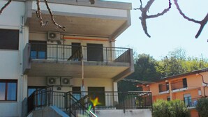 A multi-story building with balconies, a staircase, and a satellite dish. - Cala Chiara B&B (Ortona)