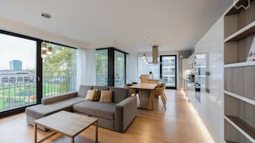 Deluxe Apartment | Living area | 50-inch flat-screen TV with cable channels, TV, heated floors