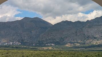 A mountainous landscape with a village in the valley.