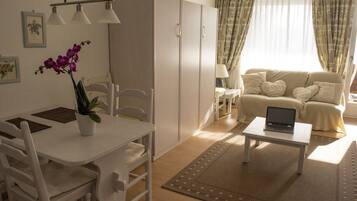 Apartment, 1 Bedroom, Balcony | Living room | Flat-screen TV