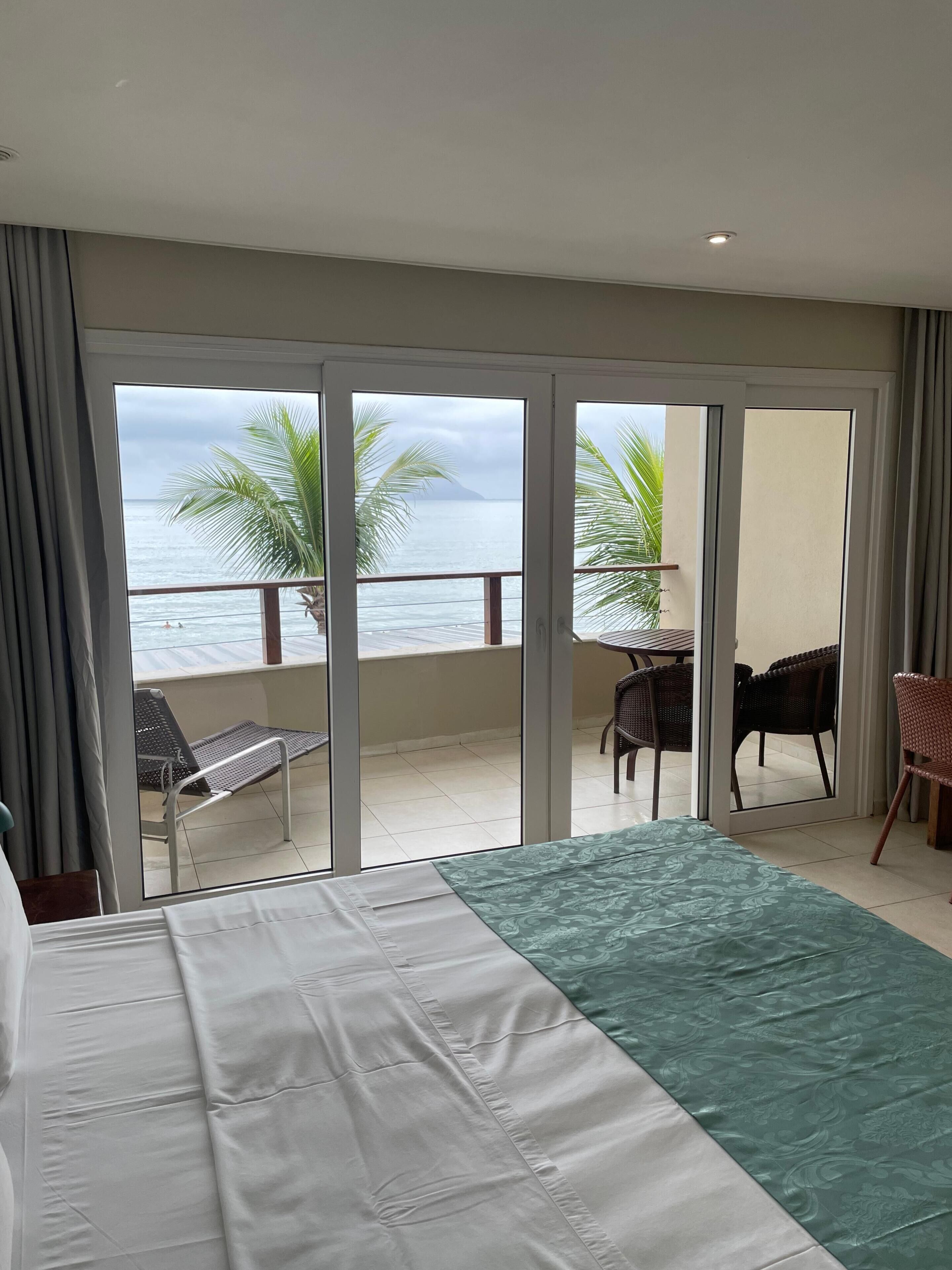 Luxury Room, Patio, Sea View | Minibar, in-room safe, soundproofing, bed sheets