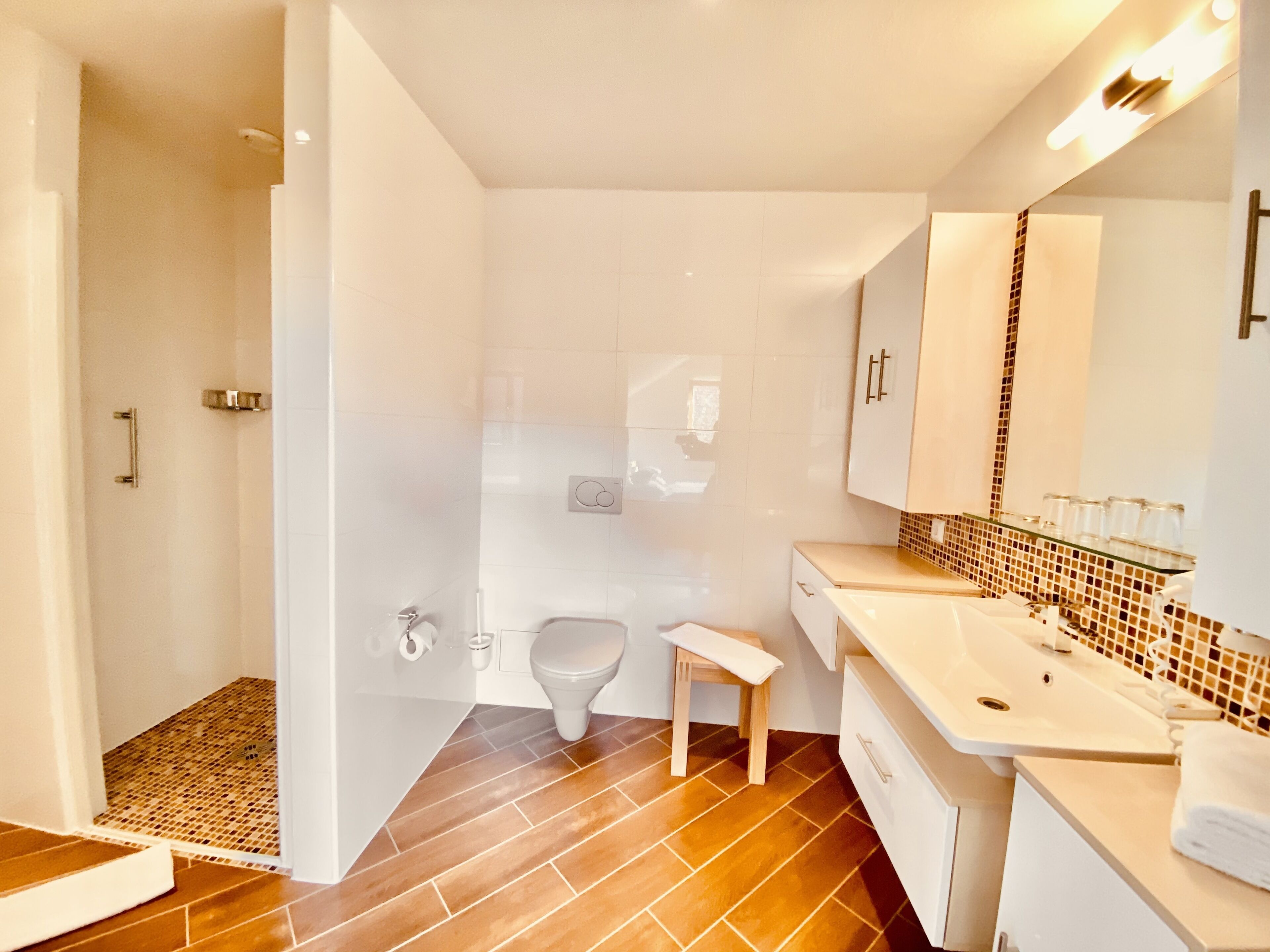 Une salle de bain moderne équipée d’une douche, de toilettes et d’un lavabo.