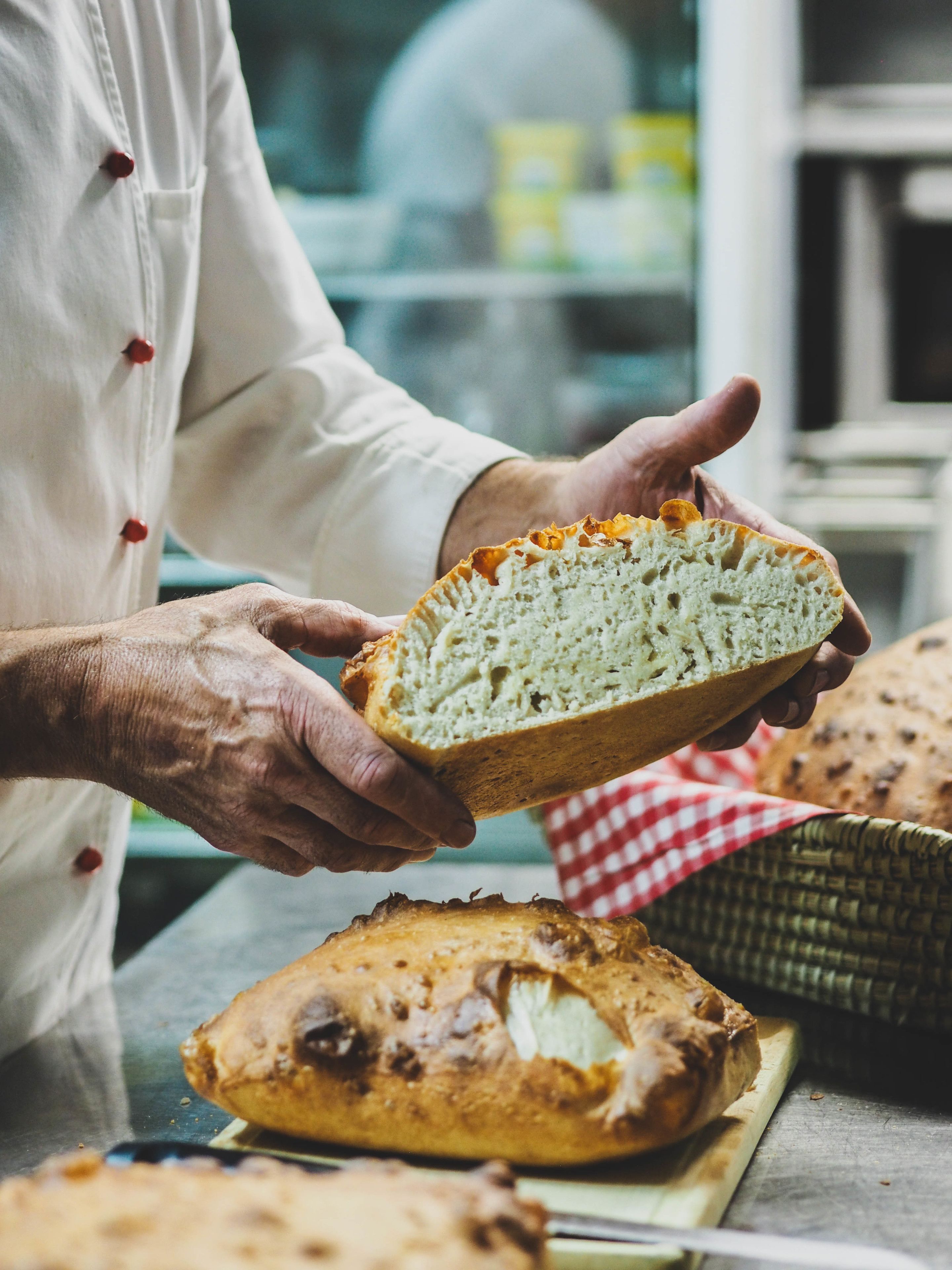 A person holding a loaf of bread.
