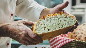 A person holding a loaf of bread.