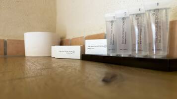 A display of The Spa Collection shower caps and a white box labeled "The Spa Collection."