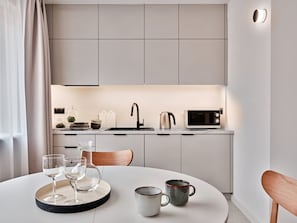 A modern kitchen with a dining area. - Media Park (Warsaw)