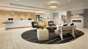 A modern hotel lobby with a reception desk, seating area, and a fireplace. - Homewood Suites By Hilton Salt Lake City Draper (Draper)
