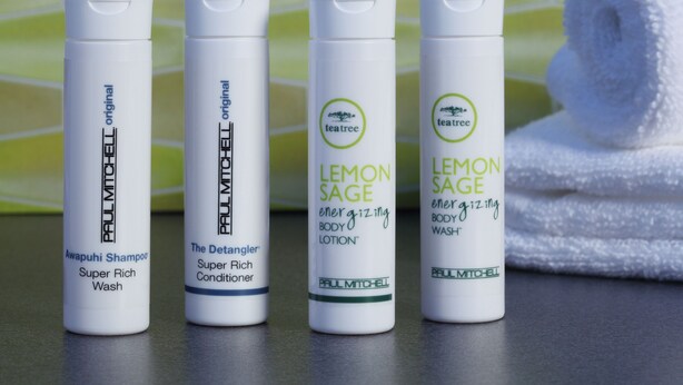 Four bottles of Paul Mitchell hair care products on a bathroom counter. - Fairfield Inn & Suites Lincoln Airport (Lincoln)