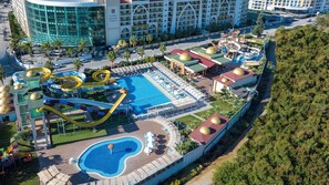 A water park with a pool, slides, and sun loungers. - Alan Xafira Deluxe Resort & Spa (Alanya)