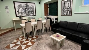 Un coin repas avec une table et des chaises, un canapé noir et une table basse.