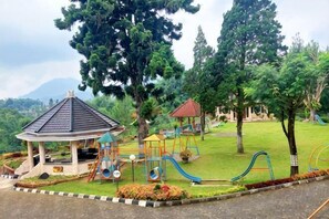 A playground with slides and a gazebo. - Sanggabuana Puncak Convention & Resort (Pacet)