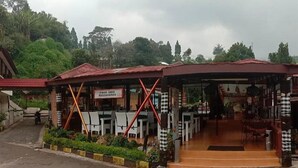 A poolside restaurant with outdoor seating and a covered entrance. - Hotel Ciloto Indah Permai (Cipanas)