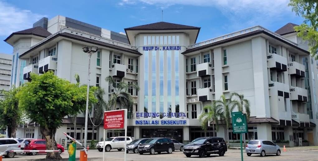 A multi-story building with a central tower labeled "RSUP Dr. KARIADI" and a sign for "GEDUNG GARUDA INSTALASI EKSEKUTIF".