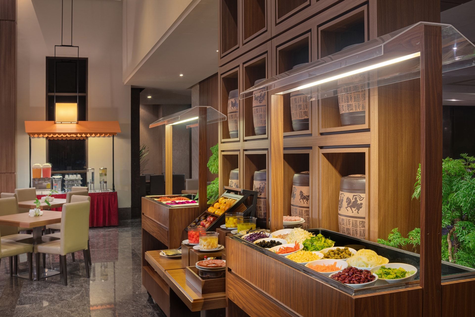 A buffet area with various food options and a seating area with tables and chairs.