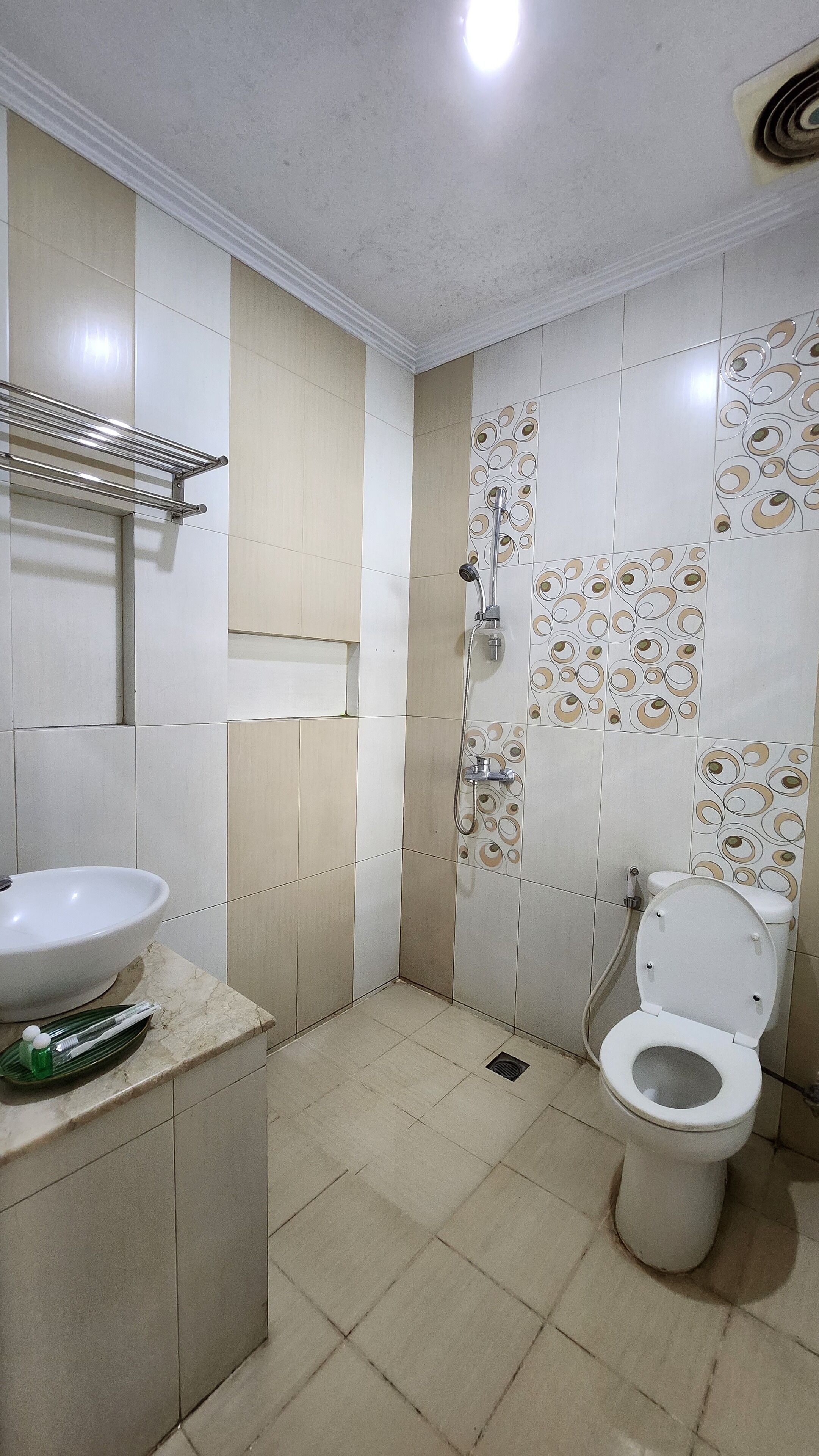 A bathroom with a white sink, toilet, and shower.