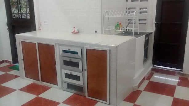 A kitchen with a white countertop, a sink, and a drying rack. - Posada Estrella del Mar (Isla de San Andres)