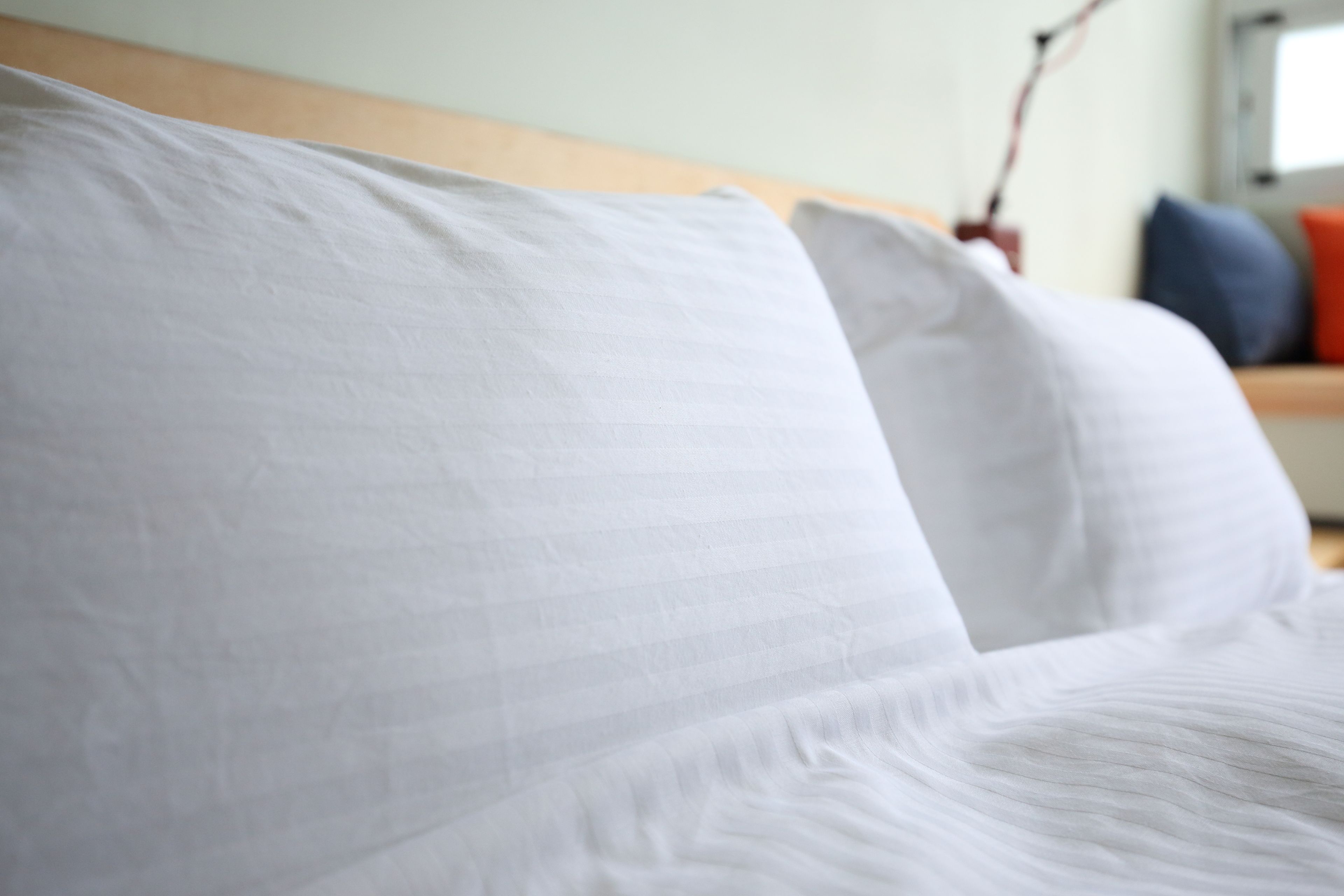 A close-up of a white bedspread with a textured pattern.
