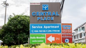 A sign for Central Place, indicating it is a service apartment with daily and monthly rates.