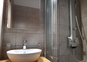 Shower, hair dryer, slippers, towels