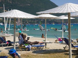 Beach nearby, sun loungers, beach umbrellas, windsurfing