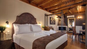 A neatly made bed with white linens and a brown headboard, a bedside table with a lamp, and a mirror reflecting the room. - Frontzu Politia (Ioannina)