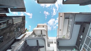 A multi-level urban building with balconies and staircases. - OwlStay Flip Flop Hostel Garden (Taipei)