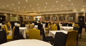 A banquet hall with multiple round tables and chairs, arranged in rows. - Sparkling Waters Hotel & Spa (Rustenburg)