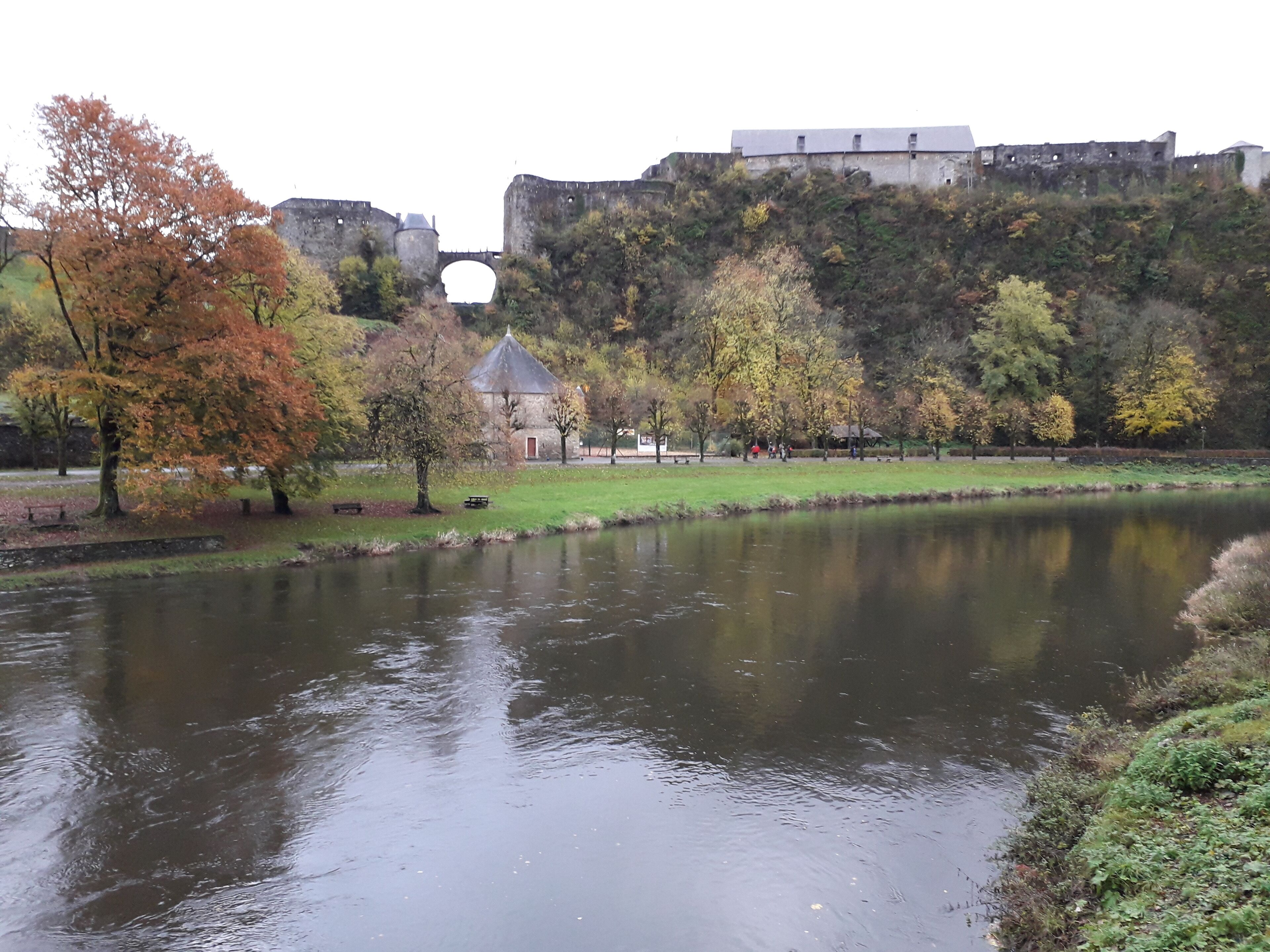 A river with a castle on a hill in the background.
