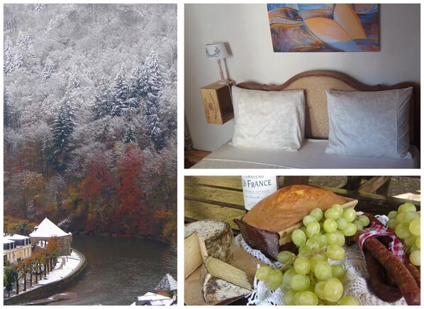 A room with a bed, pillows, a painting, and a bottle of wine.