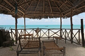 On the beach, white sand, sun loungers, beach umbrellas