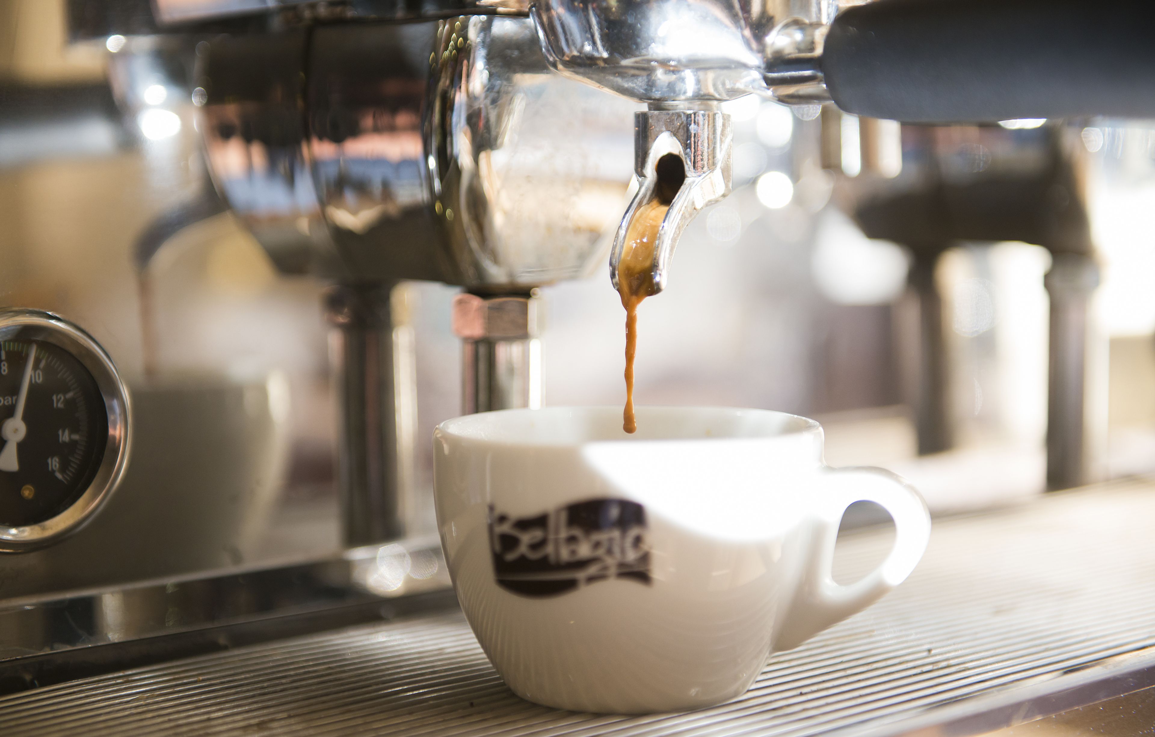 A coffee machine dispensing espresso into a cup.