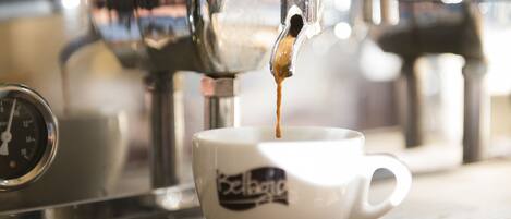 A coffee machine dispensing espresso into a cup.