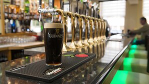 A bar with a Guinness glass on a tap, a bar mat with a red apple design, and a beer tap behind the glass. - Kilmorey Arms Hotel (Newry)