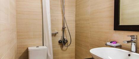 A modern bathroom with a shower, toilet, and sink.