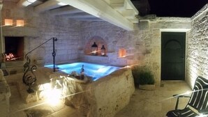 A stone-walled outdoor hot tub area with a fire feature and a small pool. - La Corte dell'Astore (Alberobello)