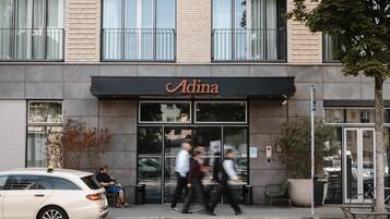 A building with a storefront named 'Adina.'