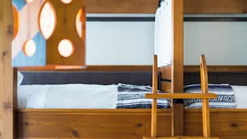 A wooden bunk bed with a headboard that has circular cutouts.